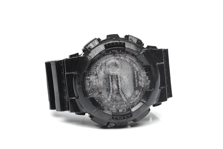 Water droplets inside a digital watch isolated / A water damaged watch