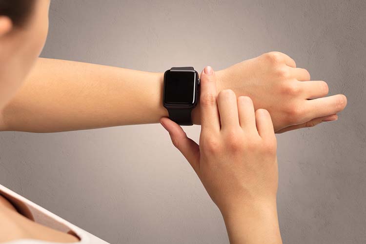 Female hand with black screen smartwatch.
