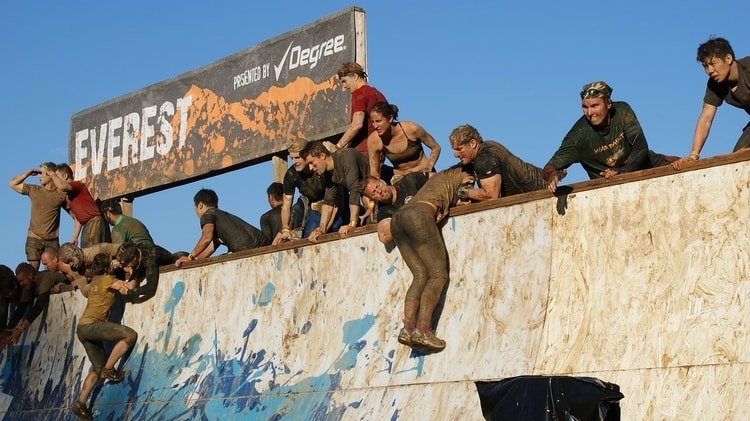 racers climbing over obstacle